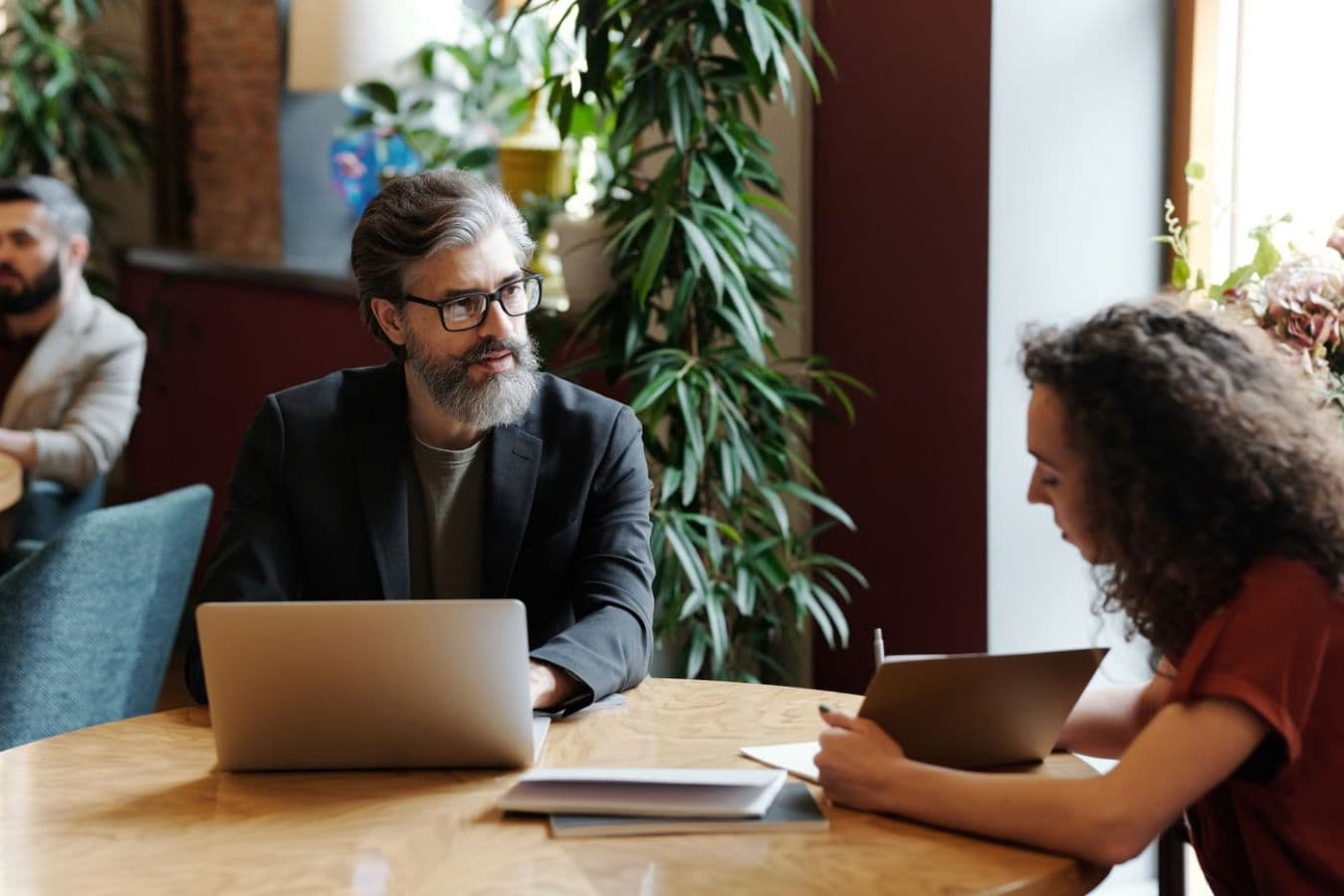 Professionals discussing campaign planning in a modern workspace.